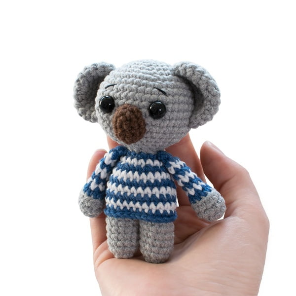 Little amigurumi koala in a striped blue and white sweater.