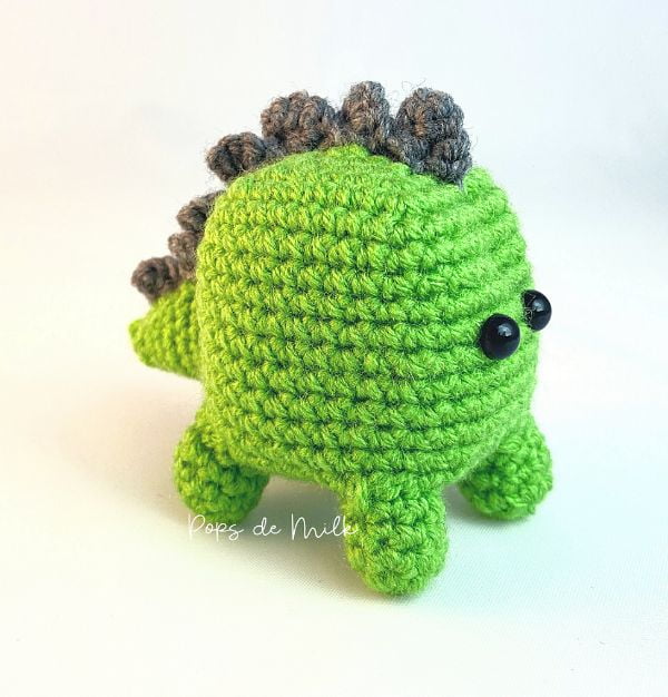 Bright green mini crochet Stegosaurus.