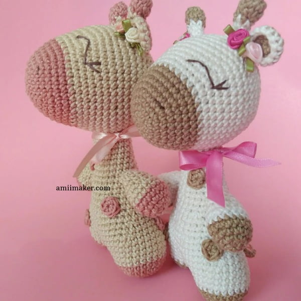 Two sweet crochet giraffe with flowers in their hair.