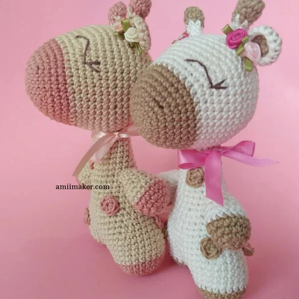 Two sweet crochet giraffe with flowers in their hair.