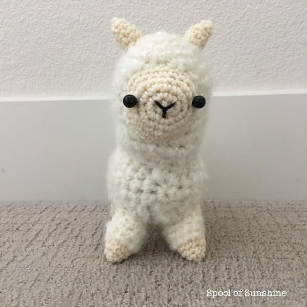 Fluffy white amigurumi llama.