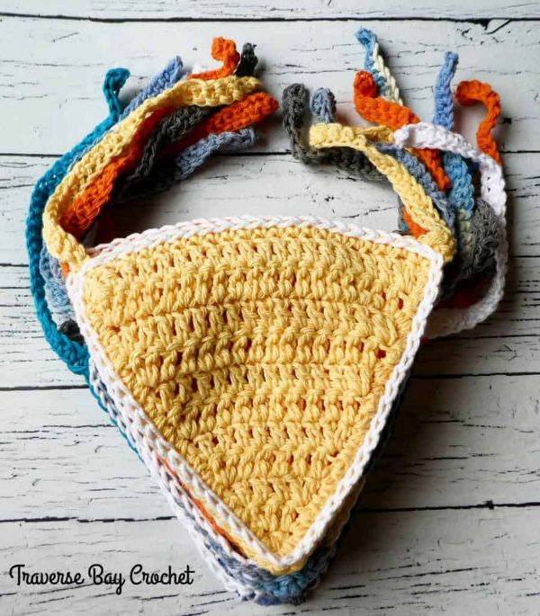 Stack of crocheted baby bandana bibs.