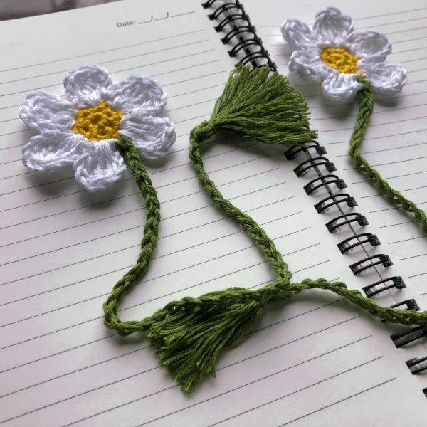 Crochet bookmark featurng a white flower.