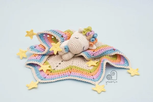 Crochet unicorn baby lovey with stars.