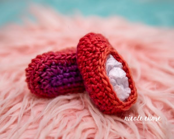 Red crochet baby booties.