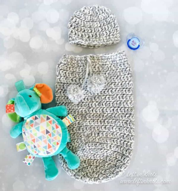 Crochet baby cocoon and hat set with elephant toy.