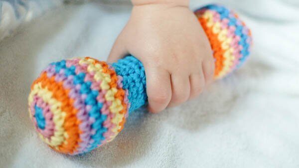 Rainbow striped crochet baby rattle.