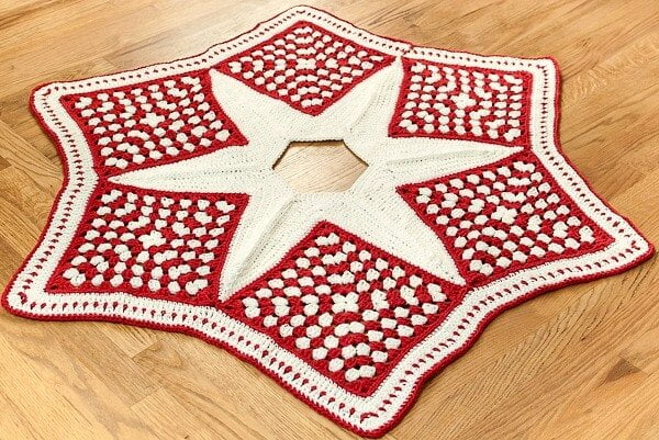 Red and white crocheted star shaped Christmas tree skirt.