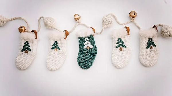 Five green and white crochet Christmas stockings.