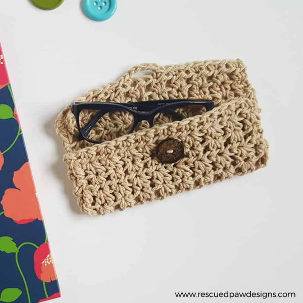 Crochet glasses case with button closure.
