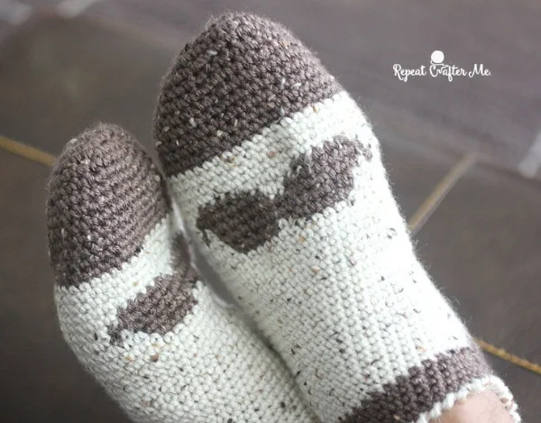 Crochet slipper socks with mustache motif.