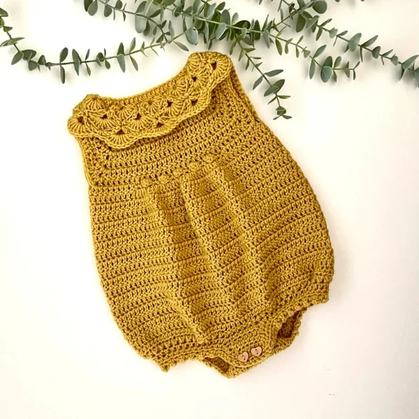 Mustard color crochet baby romper with shell stitch frill.