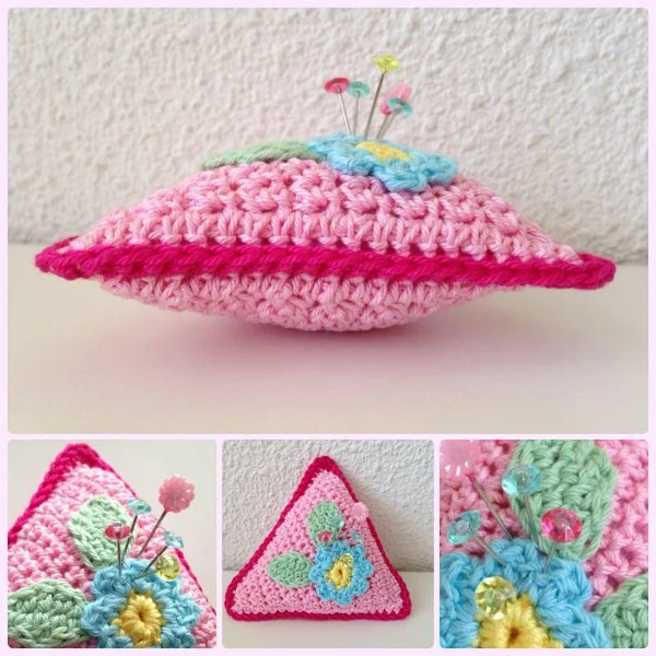 Pink triangle shaped crochet pincushion.