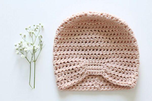 Pale pink crochet baby turban.