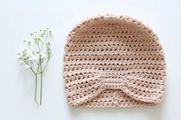 Pale pink crochet baby turban.