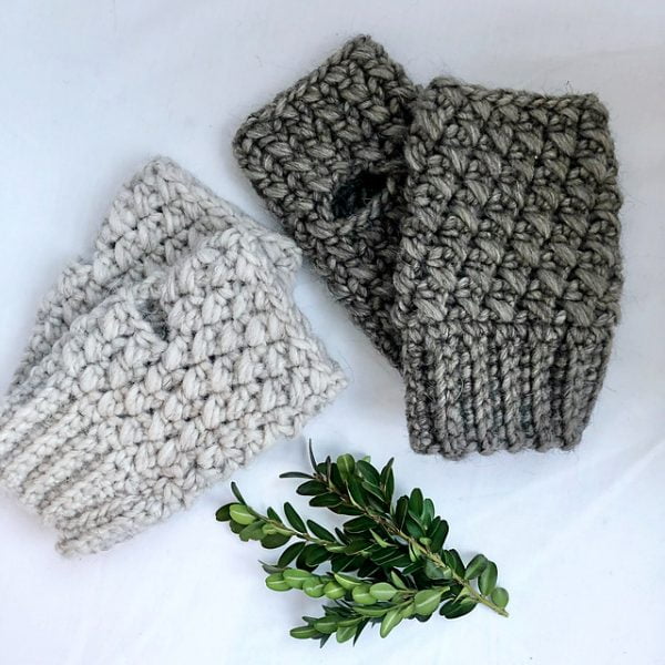 Two pairs of crossed stitch fingerless gloves.