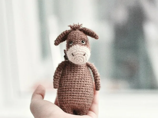 Sweet sad-faced crochet donkey amigurumi.