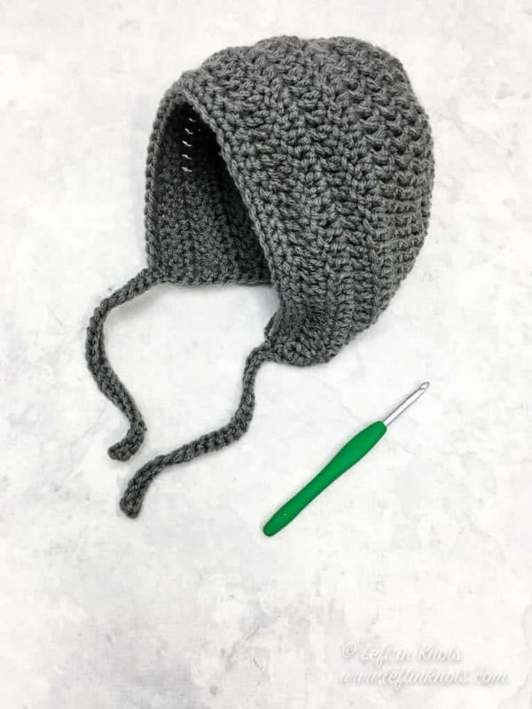 Simple gray crochet baby bonnet.