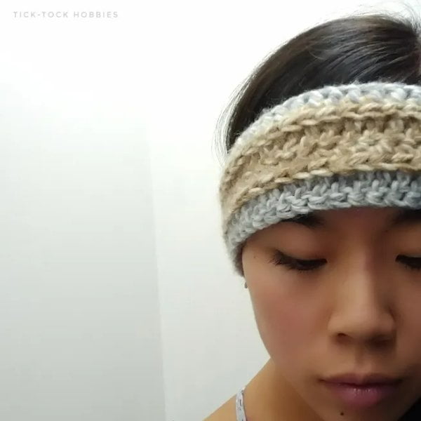 Woman wearing crochet headband with graduated color change.