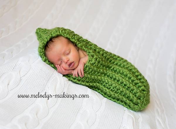 Green crocheted baby cocoon