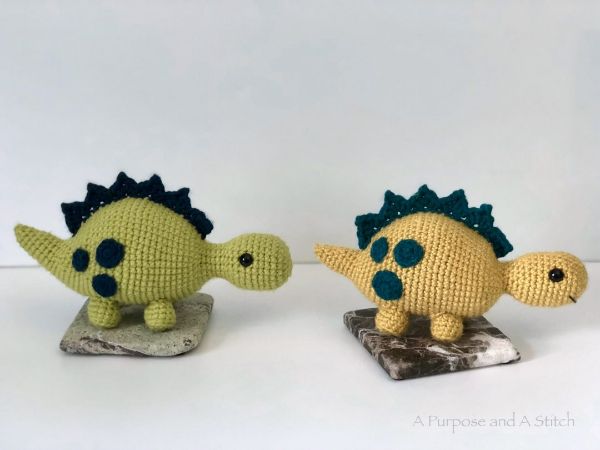 Two crocheted Stegosaurus dinosaurs.
