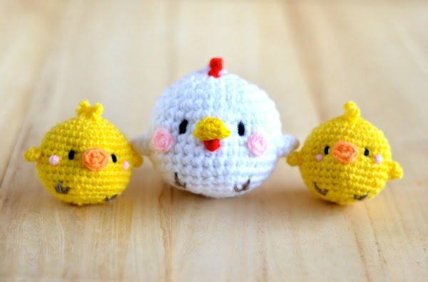 Three little crochet round chickens.