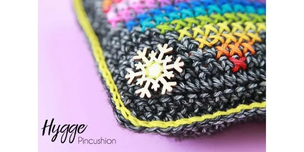 Crochet pincushion with cross stitch detail.