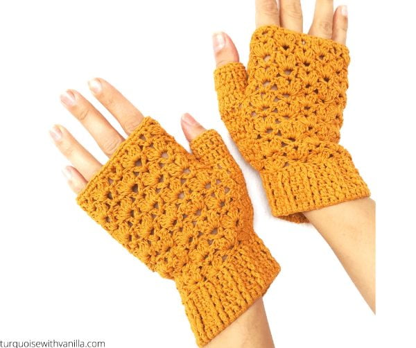 Golden yellow mittens with crochet lace pattern.