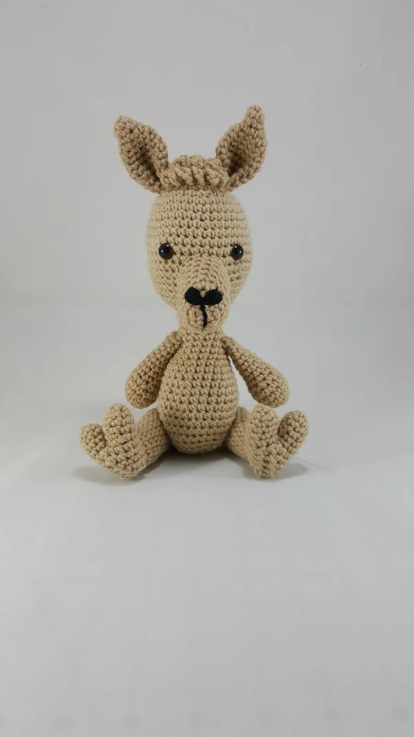Sitting corchet llama alpaca.