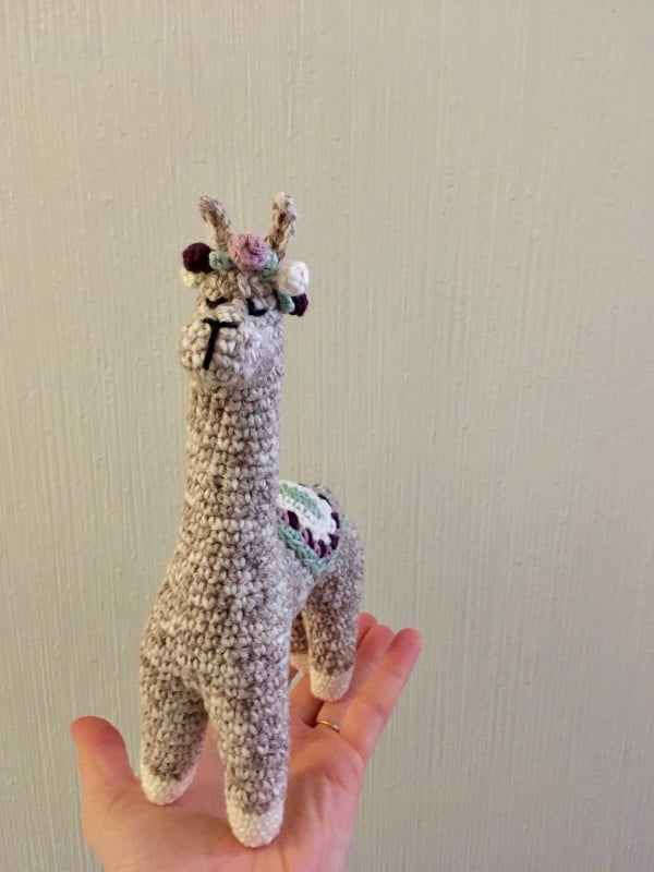 Crochet alpaca with rose crown.