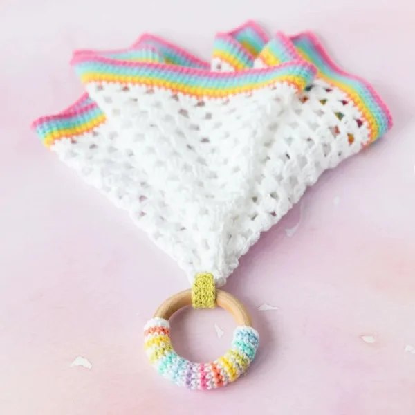 Crochet baby lovey with wooden teething ring.