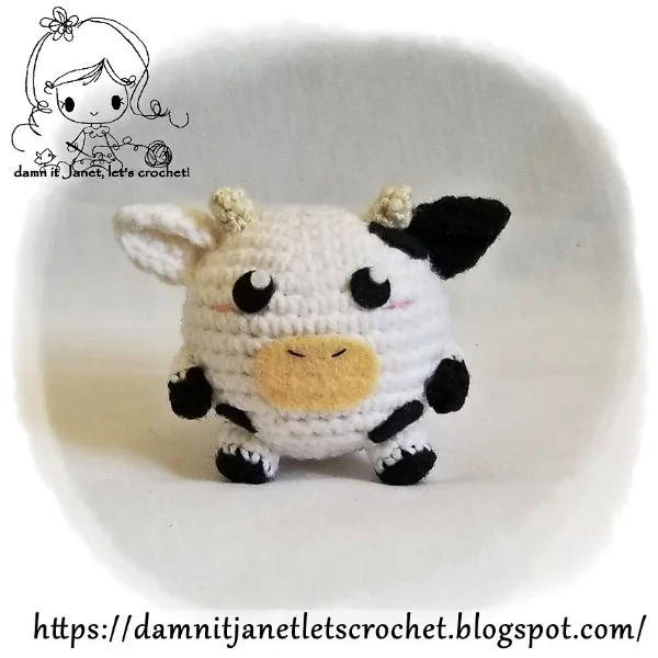 Round crochet cow plushie.
