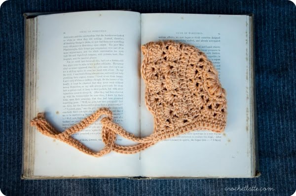 Lacy stitch crochet baby bonnet.
