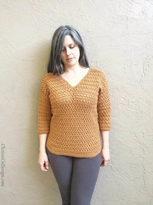 Crochet v-neck sweater with three-quarter length sleeves.