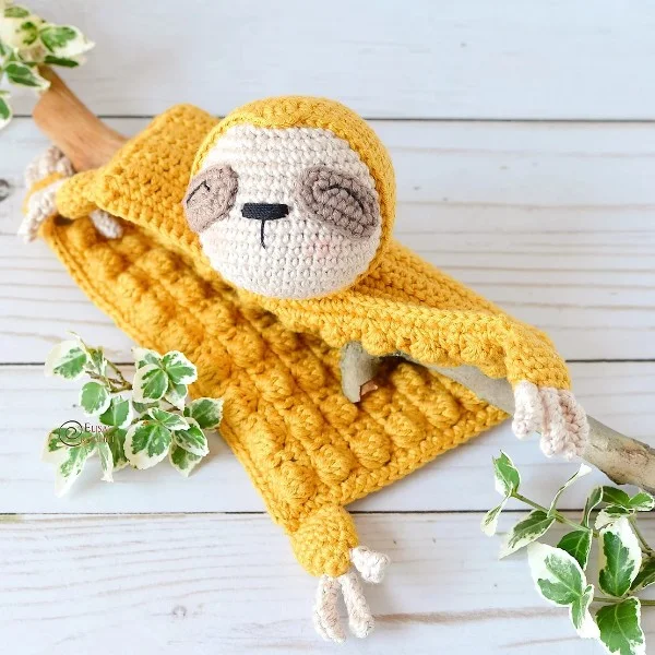 Yellow crochet sloth security blanket.
