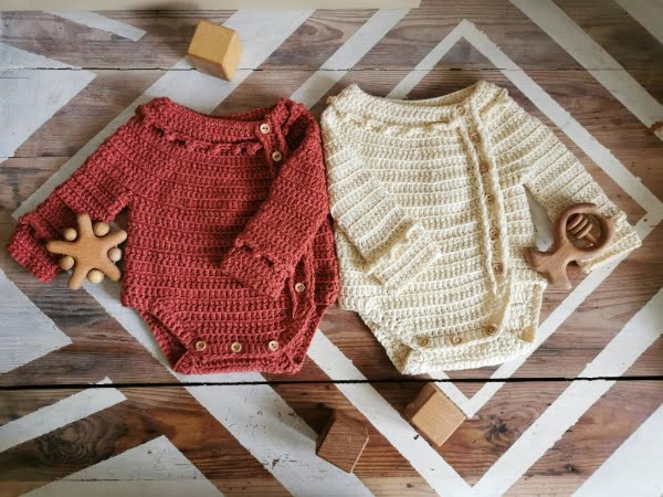 Long-sleeved crochet baby bodysuit.