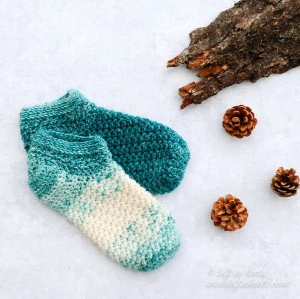 Turquoise colored crochet slippers.