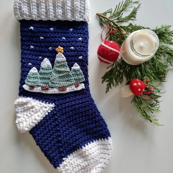 Crochet Christmas stocking with snowy Christmas tree applique.