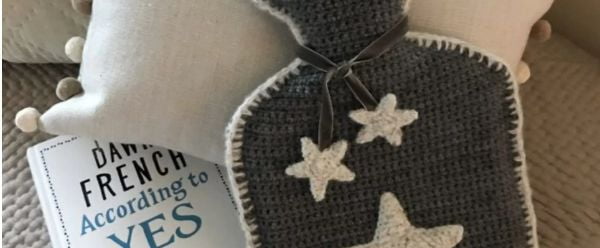 Crochet hot water bottle with star shaped applique.