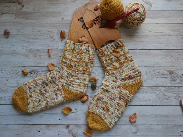 Colorwork crochet socks with grid design.