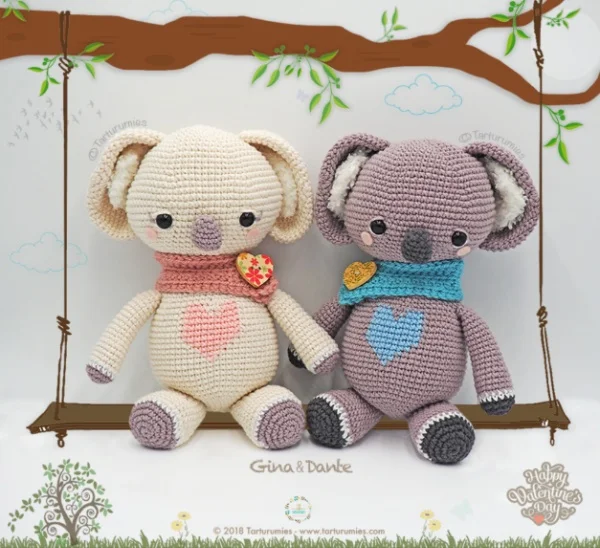 Two crochet koalas sitting on a love swing.