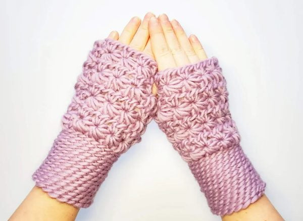Chunky star stitch crochet pink fingerless gloves.