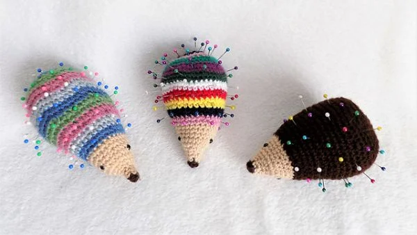 Three little crochet hedgehog pin cushions.