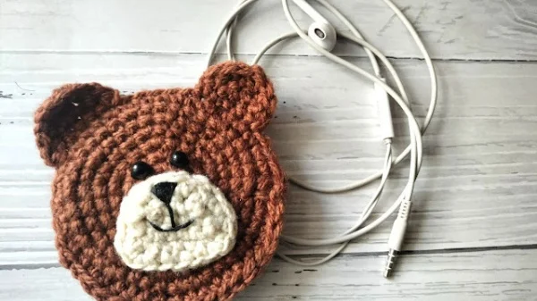 Crochet teddy bear earbud case.