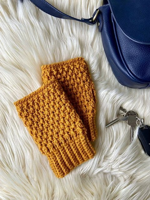 Golden yellow crochet fingerless gloves.