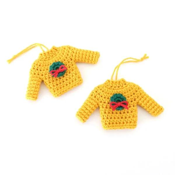 Crochet yellow sweater christmas tree ornaments.