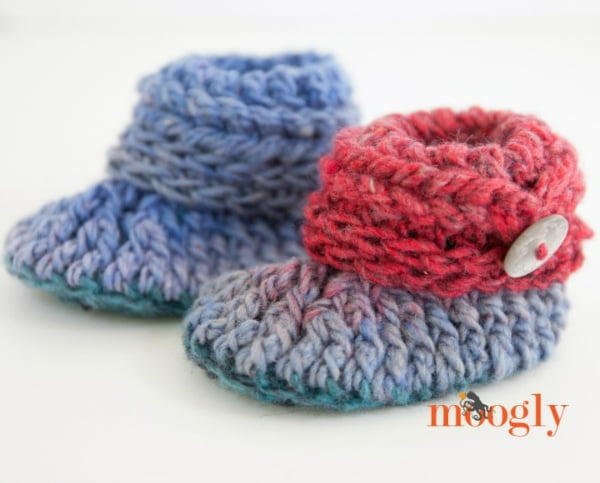 Crocheted baby booties with button detail.