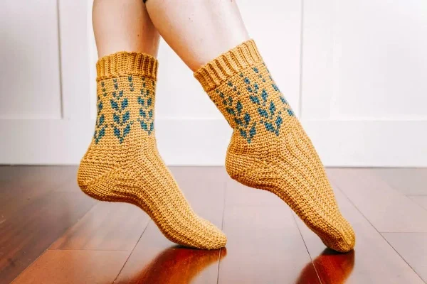 Yellow crochet socks with colorwork pattern.