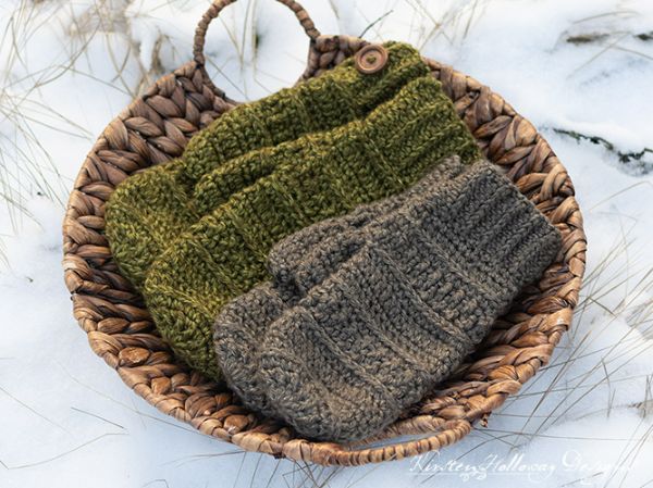 Two pairs of crochet mittens in a basket.