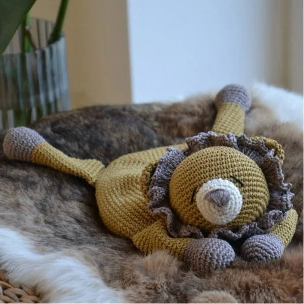 Crocheted lion baby lovey.